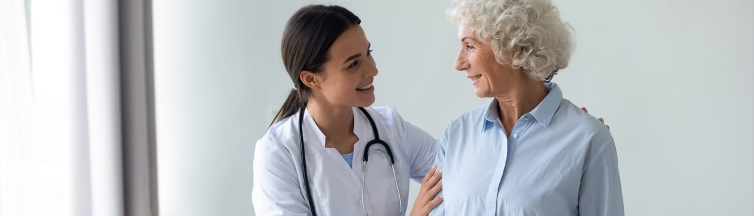 A nurse assists a patient/resident in a nursing home or assisted living community