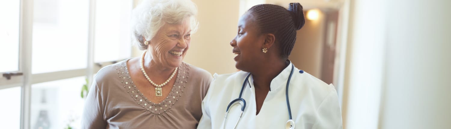 A nurse with a patient in a nursing home or assisted living facility