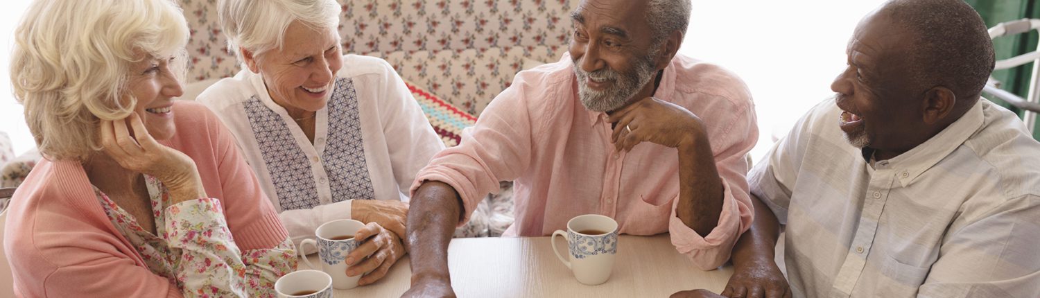 A group of senior people playing chess (nursing home or assisted living scene)