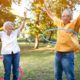 Two older adults playing with hoolahoops - long and happy life